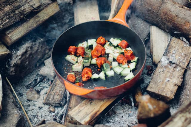 cooking meat and vegetables in a pan