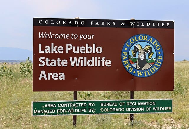 Colorado Parks and Wildlife - https://upload.wikimedia.org/wikipedia/commons/thumb/0/0f/Pueblo_Reservoir_State_Wildlife_Area_sign.JPG/640px-Pueblo_Reservoir_State_Wildlife_Area_sign.JPG