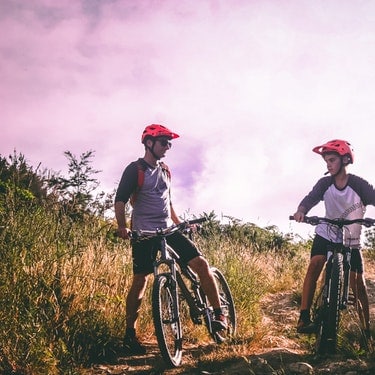 two boys riding a bicycle