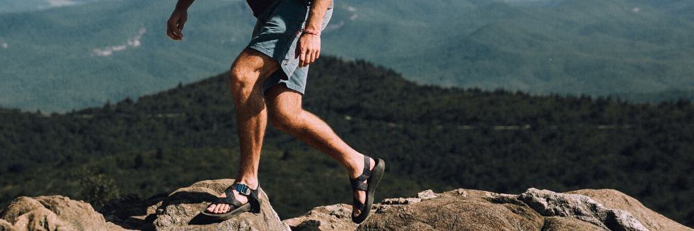 man-on-sandals-hiking-the-mountains