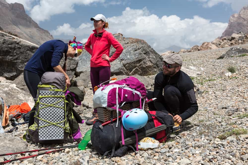 Hikers fixing their backpacks