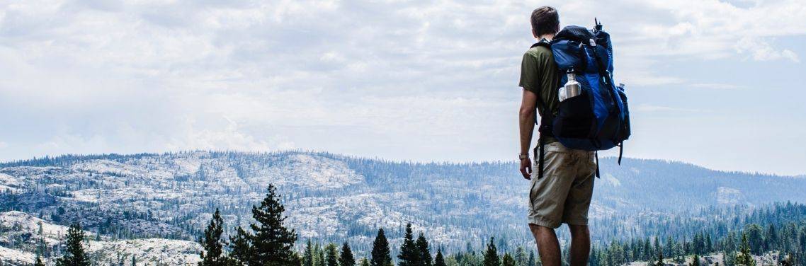 man-hiking-the-woods-with-backpack